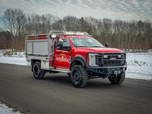 Front driver-side view with black grille guard and elevated suspension.